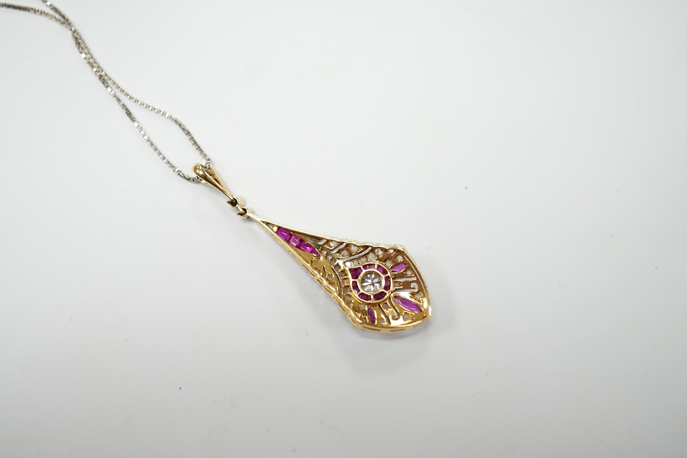 A Belle Époque pierced yellow metal, pink sapphire and diamond cluster set drop pendant, 44mm, on a later 9ct white gold chain, 44cm, gross weight 5.2 grams. Good condition.